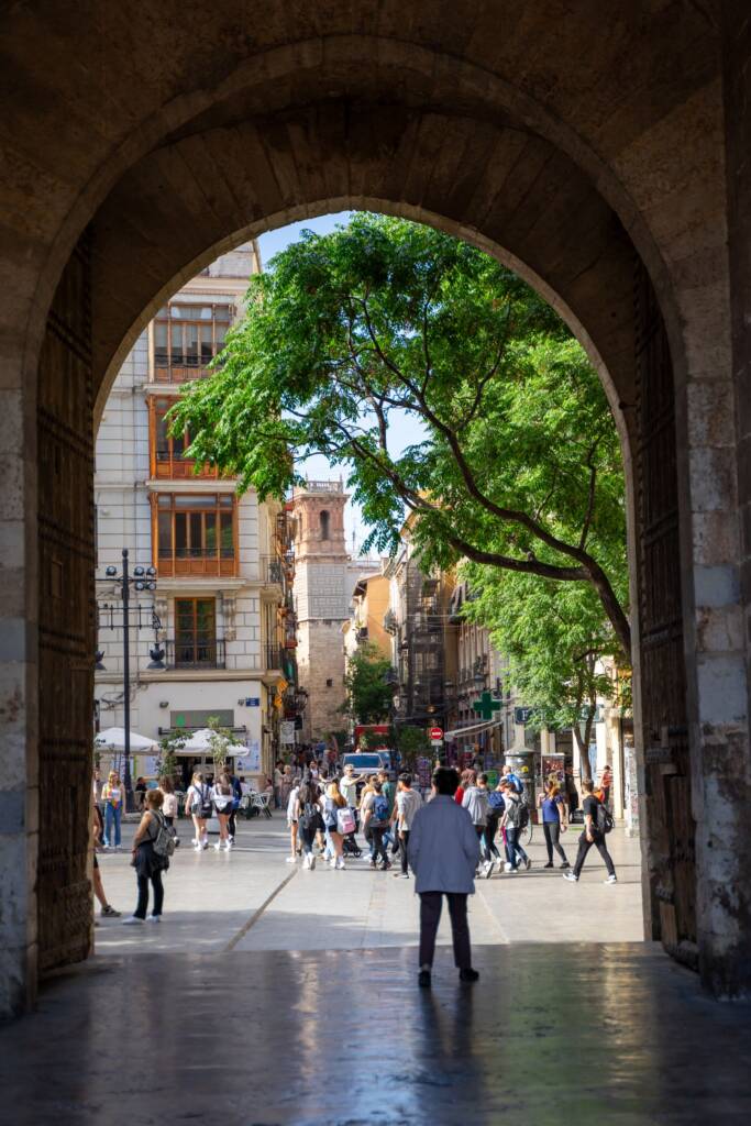 Straatbeeld in Valencia gezien door een historische boog