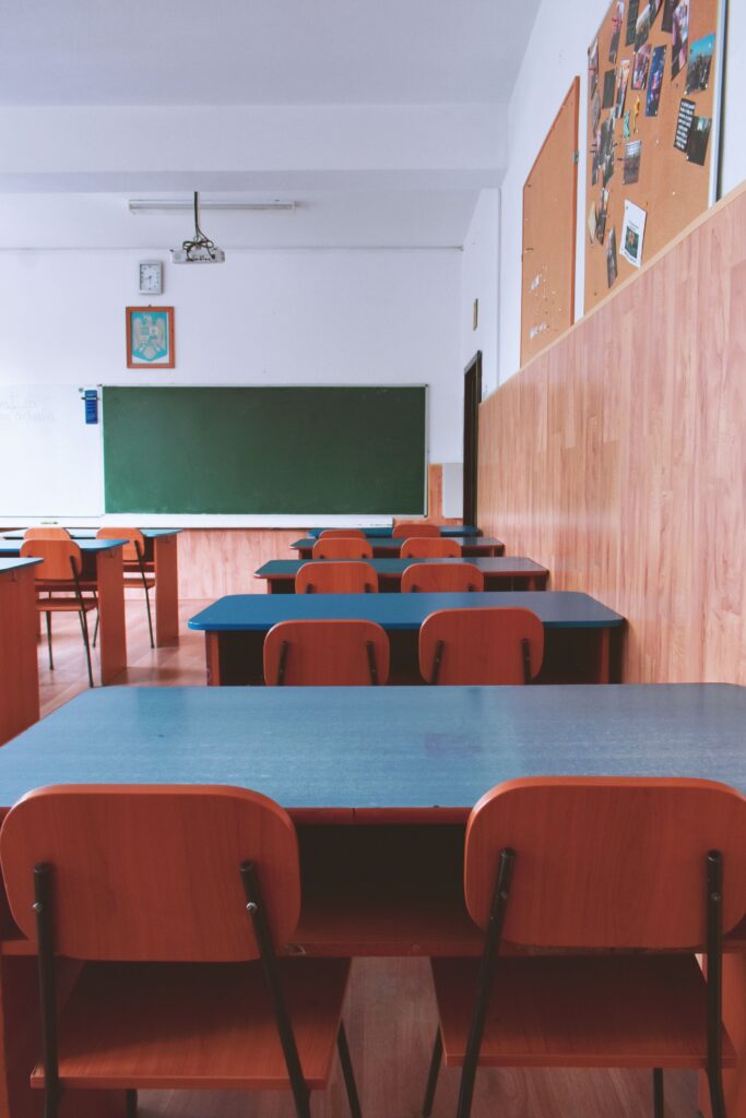 Empty classroom with a green chalkboard