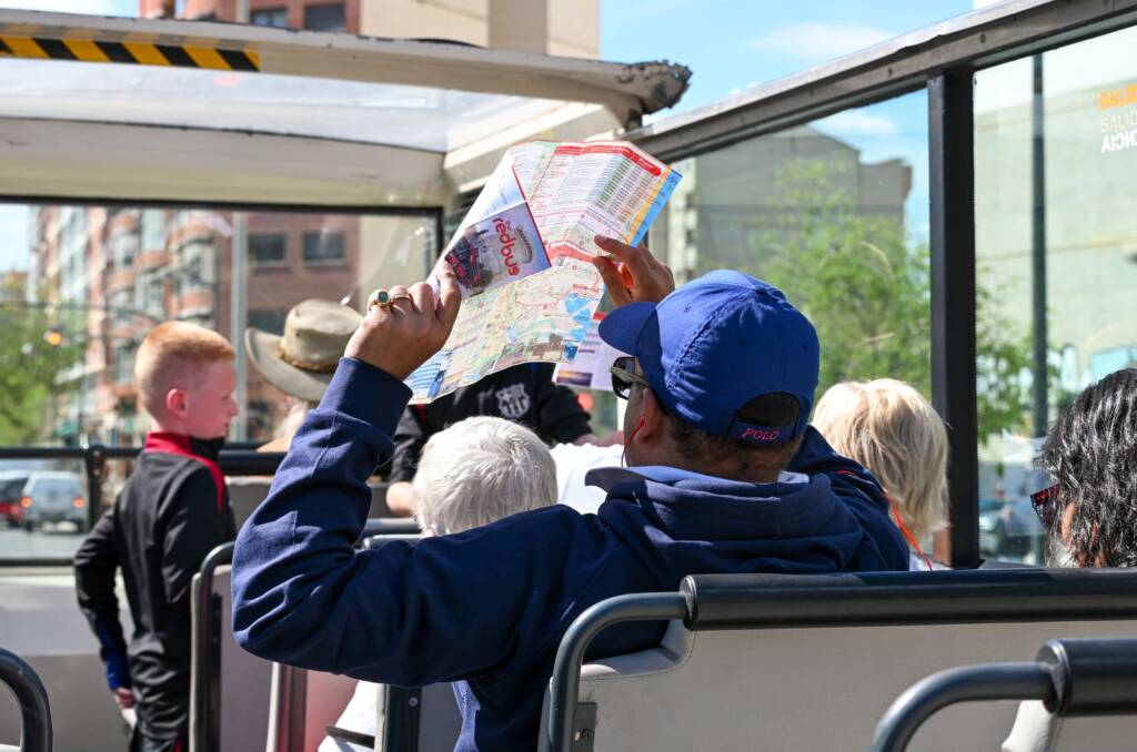 Visitors on an open-top sightseeing bus in Valencia