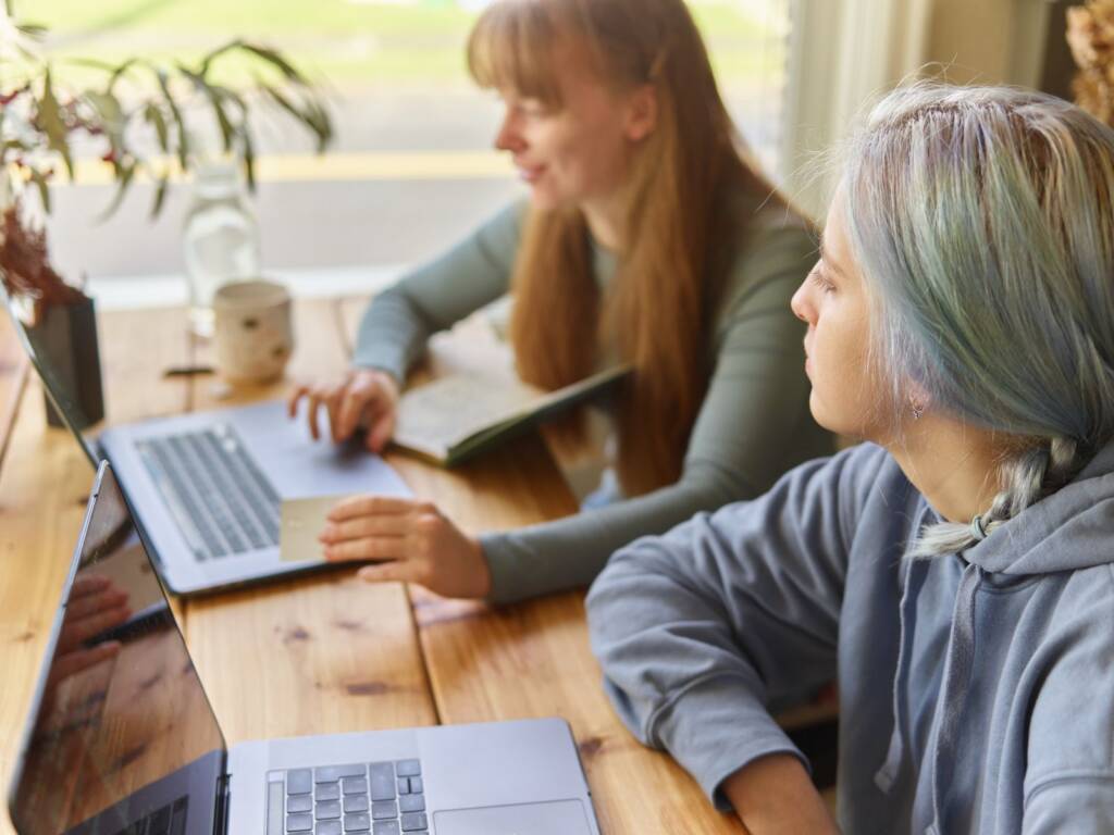 Two colleagues planning an Erasmus+ project on their laptops